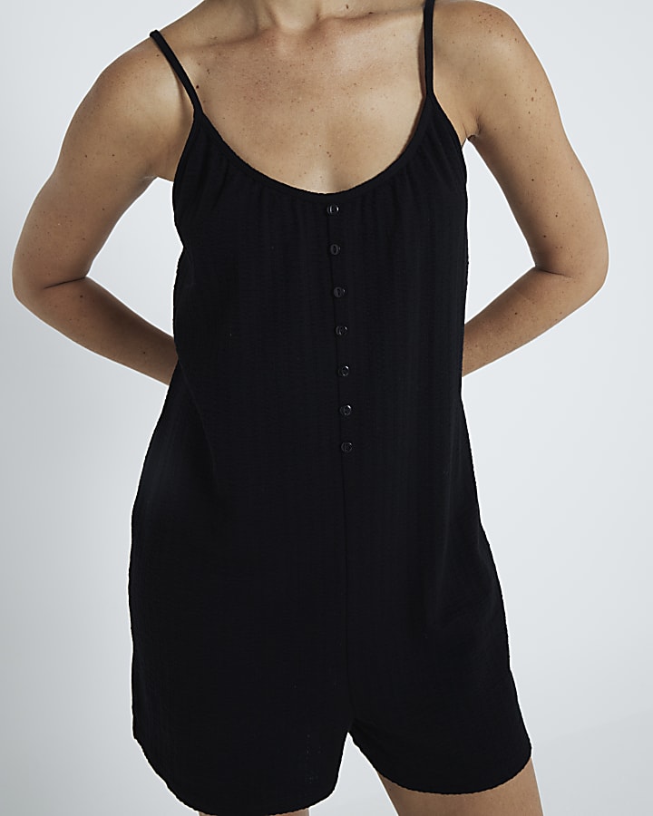 Black sleeveless button detail playsuit