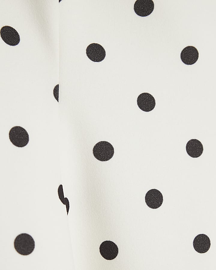 Cream Polka Dot Sleeveless Peplum Panel Top