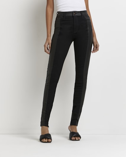 Black faux leather paneled skinny jeans