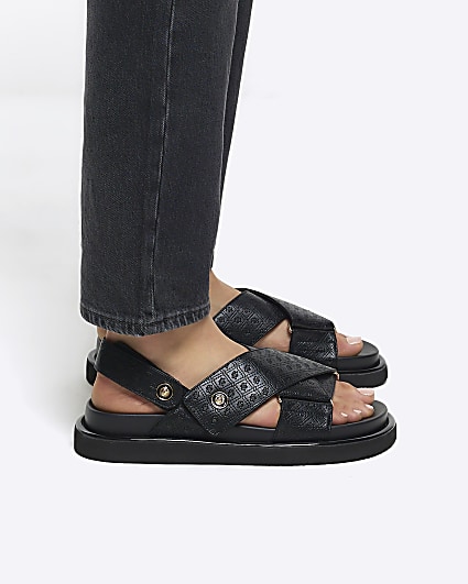 Black embossed crossed sandals