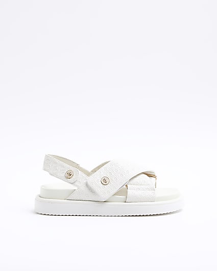 Beige embossed crossed sandals