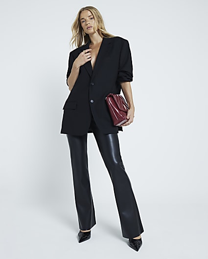 Black faux leather pull on flared trousers