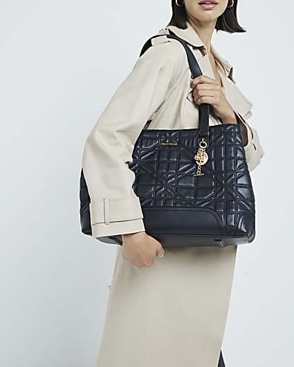 Black quilted charm tote bag