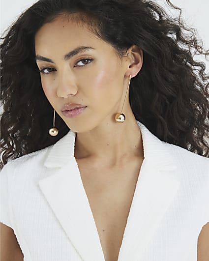 Gold long ball drop earrings