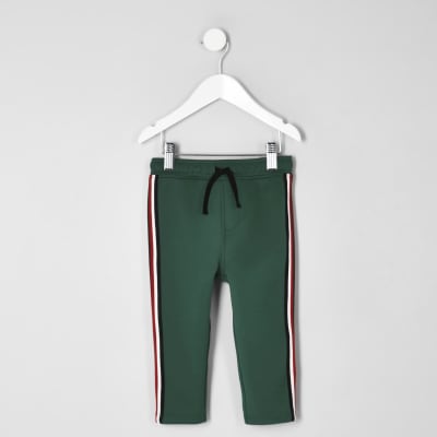 Mini boys dark green tape tracksuit bottoms River Island