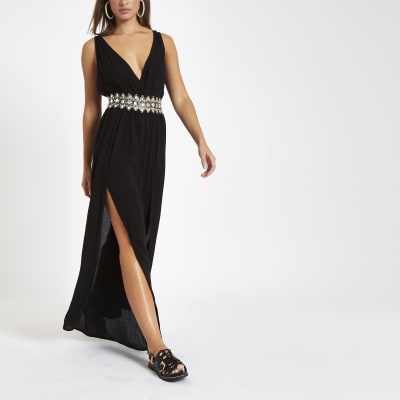 Zwarte diepuitgesneden beach jumpsuit met diamantjes bij de taille