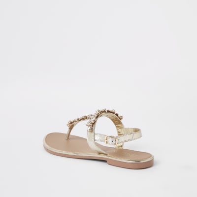 Goldene, verzierte Ledersandalen