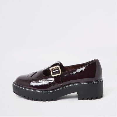 Dark red patent brogue shoes