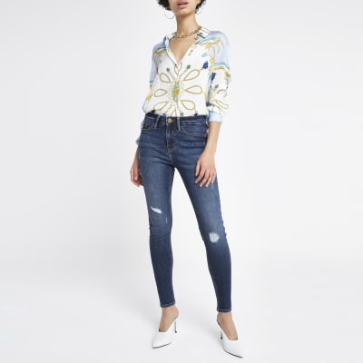 Molly - Middenblauwe denim ripped jegging met halfhoge taille