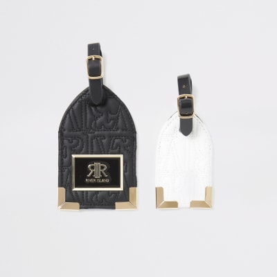 Zwarte set bagagelabels met RI in reliëf