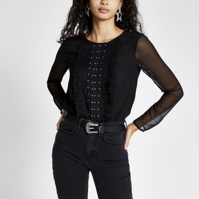 Zwarte bodysuit met lange doorschijnende mouwen en ruches voor