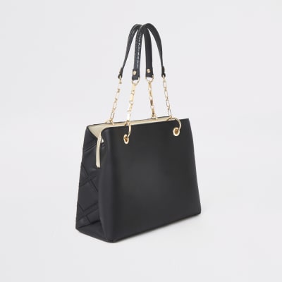Black quilted studded tote bag