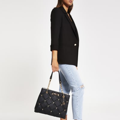Black quilted studded tote bag
