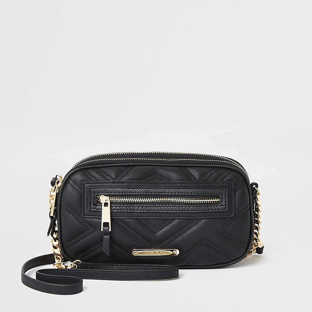 Black quilted mini cross body bag | River Island