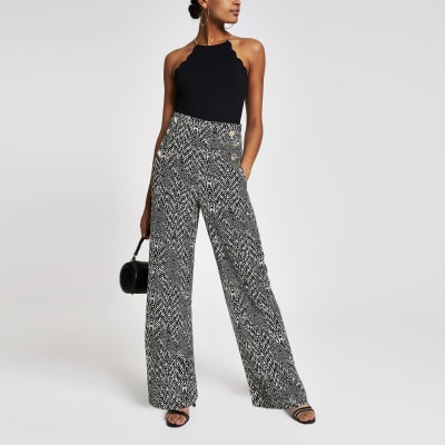 Zwarte broek met wijde pijpen, print en knopen