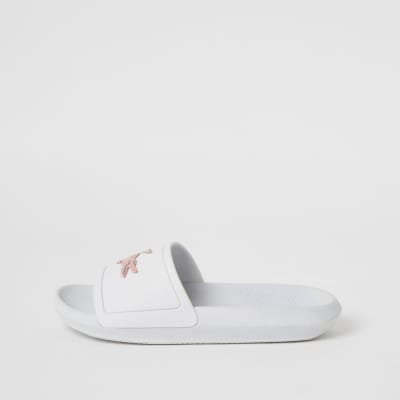 Lacoste – Claquettes blanches avec logo en relief