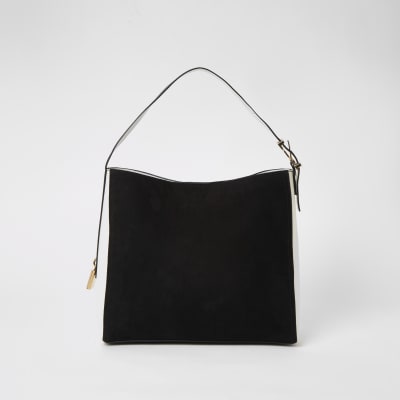 Sac souple noir en suédine avec cadenas sur le côté