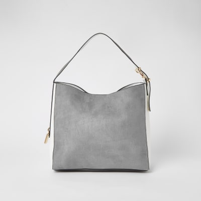 Sac souple gris en suédine avec cadenas sur le côté