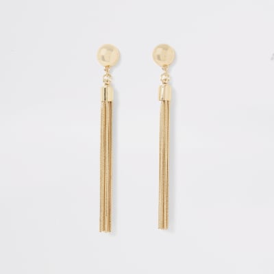 Goudkleurige oorhangers met studs en kwastjes