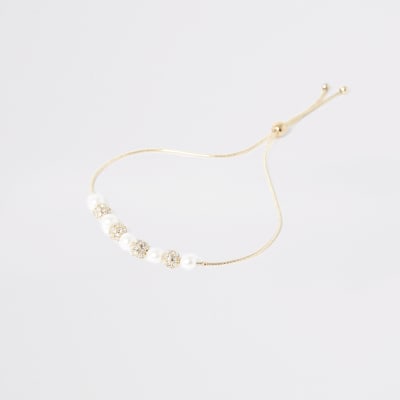 Gouden armband met parels, siersteentjes en kralen