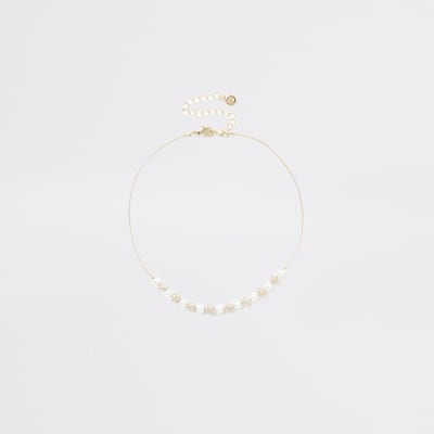 Gouden chokerketting met parels, siersteentjes en kralen