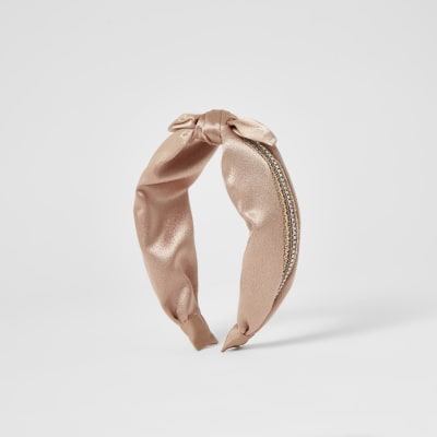 Pinker Haarreif mit Verzierung und Knoten oben