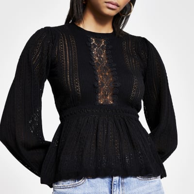 Pull péplum​​​​​​​ noir en maille et dentelle
