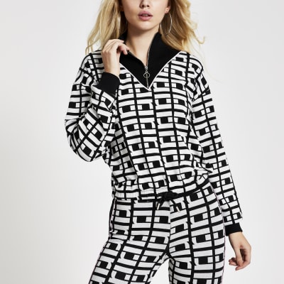 Zwarte gebreide top met RI-monogram en halve rits