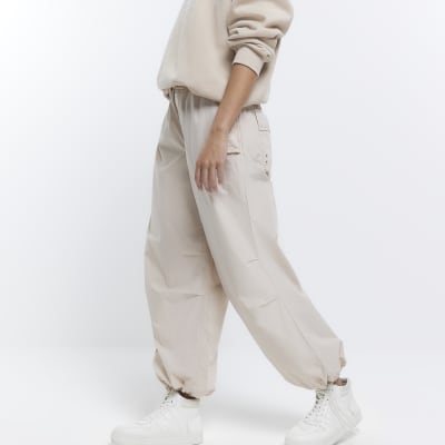 Beige low rise parachute trousers | River Island