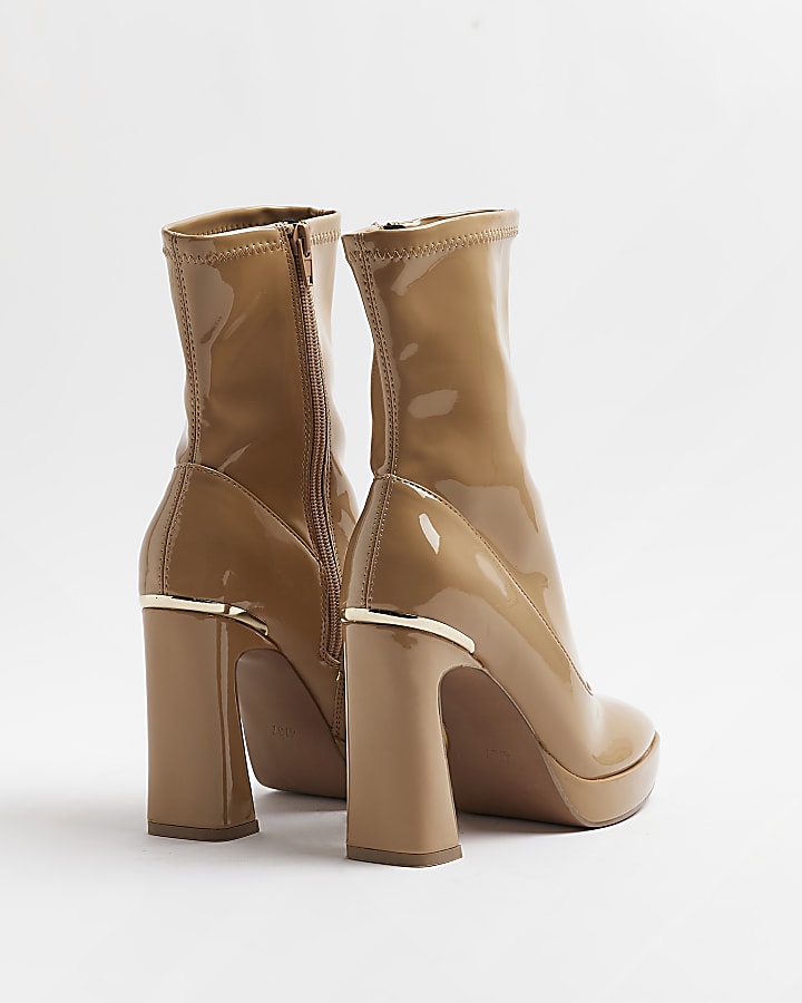 Beige patent heeled ankle boots