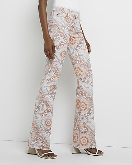 Beige printed mid rise flared jeans