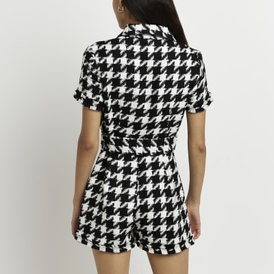 Black dogtooth boucle belted playsuit River Island