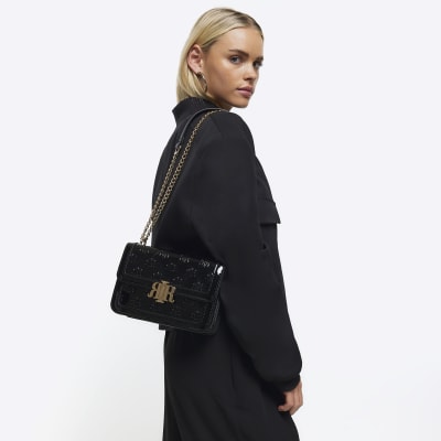 Black embossed RI lock shoulder bag River Island