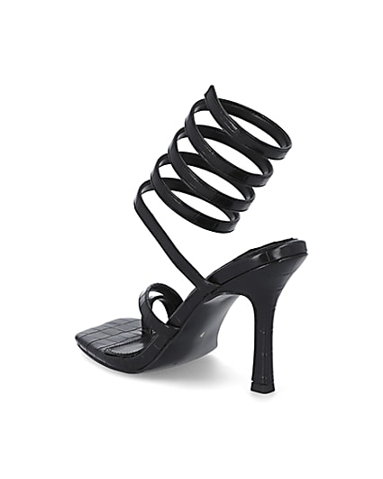 360 degree animation of product Black faux leather ankle wrap heels frame-6