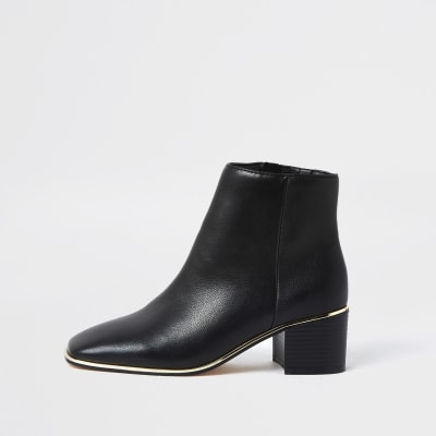 black ankle boots with gold trim