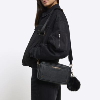 Black faux leather pom pom cross body bag River Island