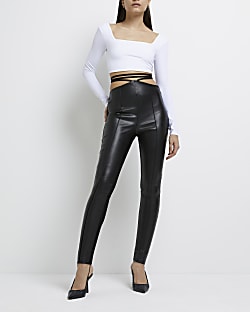 Black faux leather strap skinny trousers
