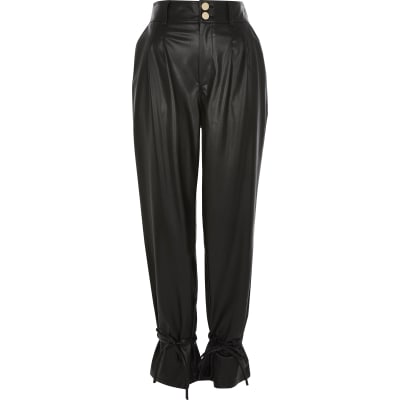 Black faux leather tie bottom trousers