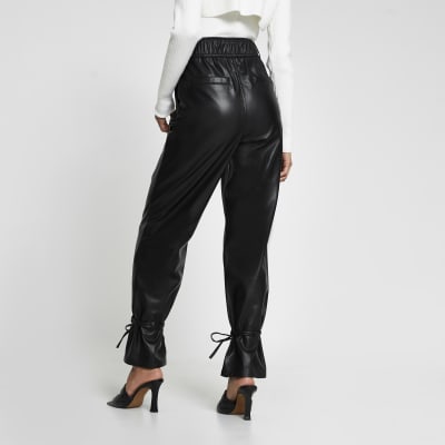Black faux leather tie bottom trousers