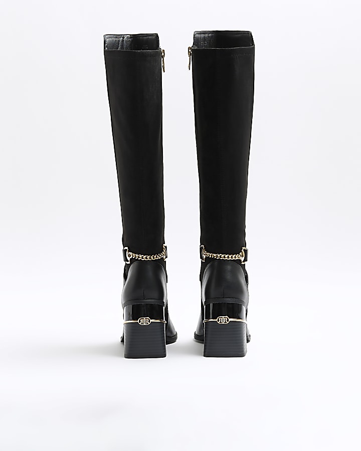 Black heeled high leg boots
