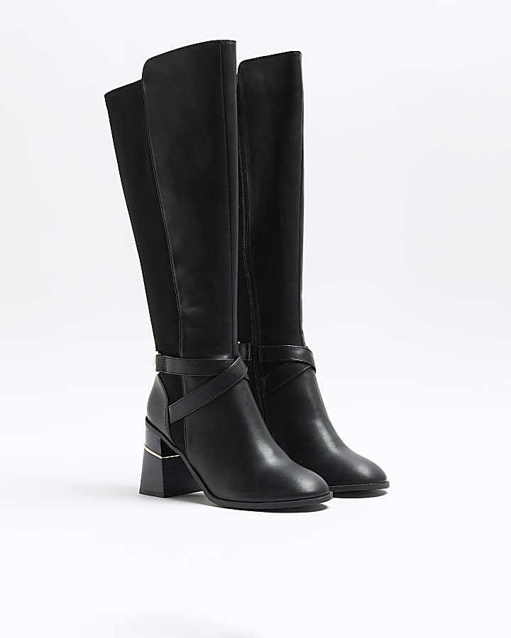 Black heeled high leg boots
