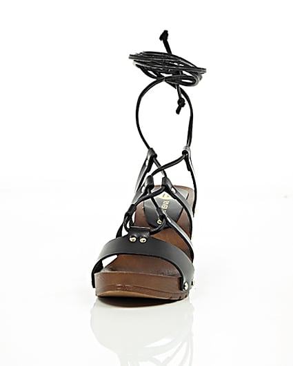 360 degree animation of product Black leather tie up clog sandals frame-3