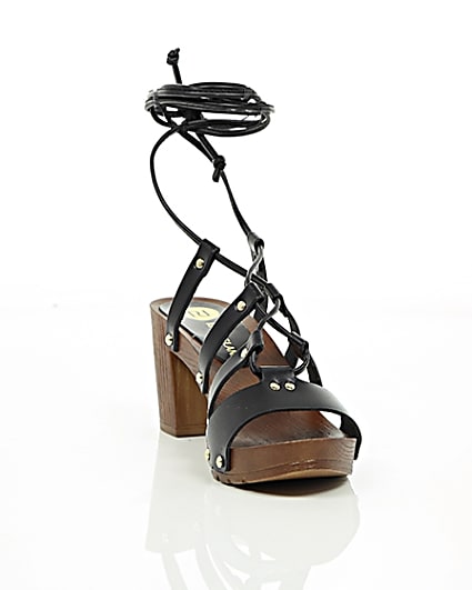 360 degree animation of product Black leather tie up clog sandals frame-5