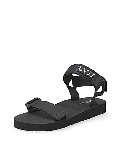 360 degree animation of product Black 'LVII' velcro strap sandals frame-0