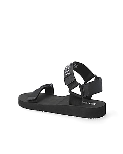 360 degree animation of product Black 'LVII' velcro strap sandals frame-5