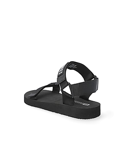 360 degree animation of product Black 'LVII' velcro strap sandals frame-6
