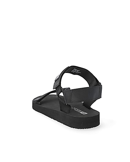 360 degree animation of product Black 'LVII' velcro strap sandals frame-7