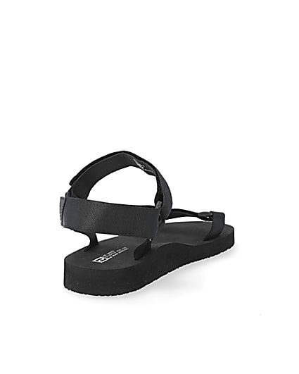 360 degree animation of product Black 'LVII' velcro strap sandals frame-11