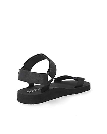 360 degree animation of product Black 'LVII' velcro strap sandals frame-12
