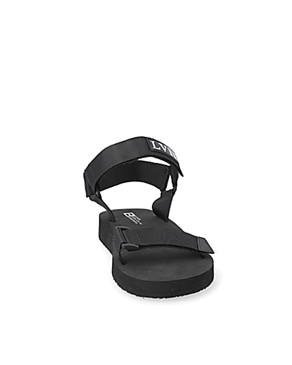 360 degree animation of product Black 'LVII' velcro strap sandals frame-20